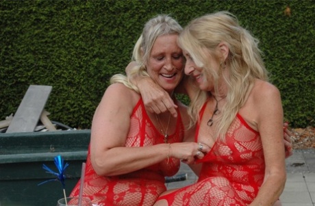 Older Blonde Lesbians Kiss On The Lips In Matching Sets Of Red Lingerie