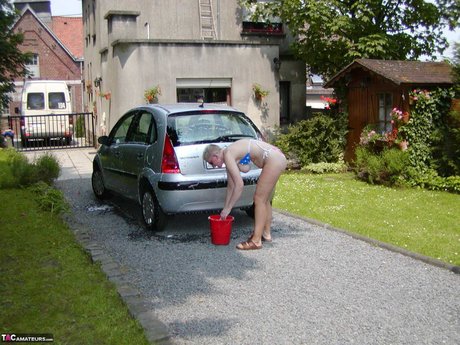 Older Blonde Tiffany Pearl Washes Her Car While Wearing A Bikini