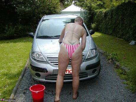 Older Blonde Tiffany Pearl Washes Her Car While Wearing A Bikini