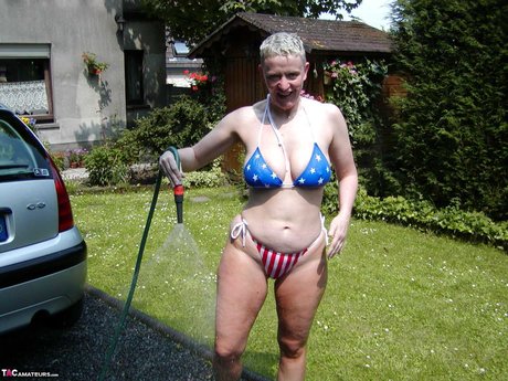 Older Blonde Tiffany Pearl Washes Her Car While Wearing A Bikini