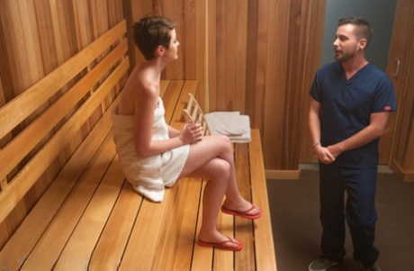 Prior to BDSM sexual activity, an all-white female with short hair is removed from a sauna.