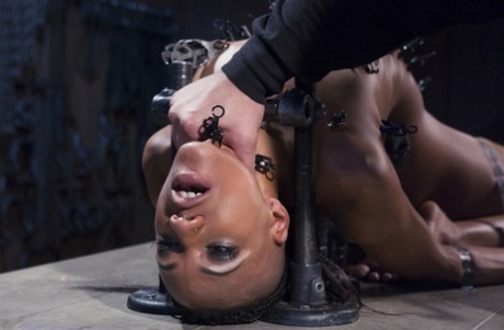 In one dungeon crawl, the Ebony girl is tortured and masturbated while in bondage.