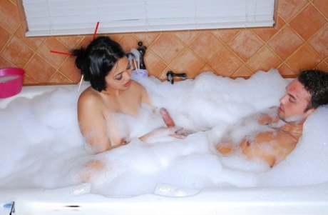 A male recipient is stimulated by a masculine penis while being massaged with soapy water by Asian-American massage therapist Mika Tan.