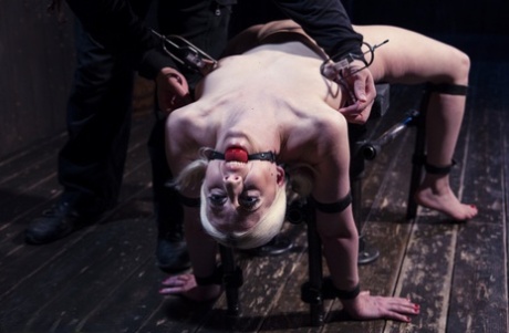 While in bondage, a sadistic man torments a seductive blonde.