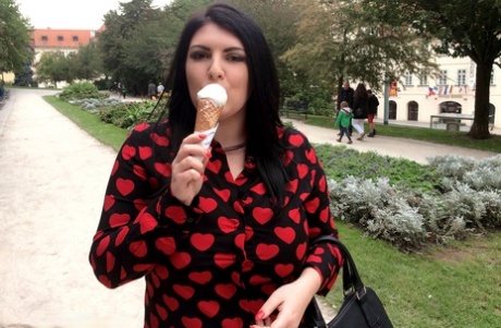 Laughing out loud: Chubby brunette Maya Milano puts her hands on an ice cream cone and enjoys eating it.