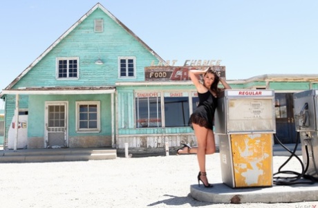 Leggy brunette Allie Haze slips off black lingerie outside abandoned building