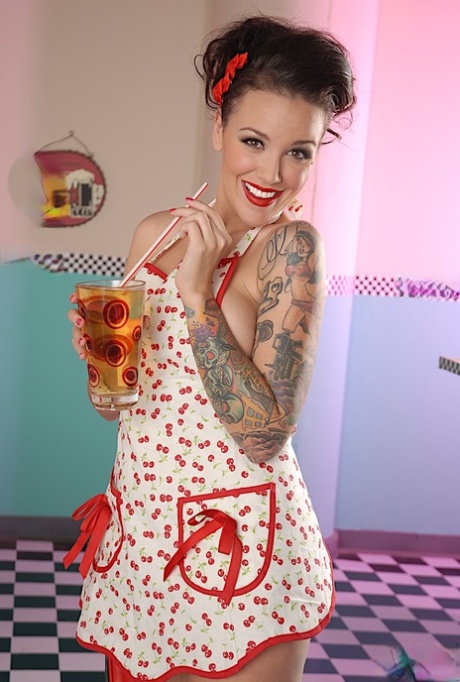 A diner table was graced by the nude waitress Emily Parker, who wore a retro sweater and spread her apron on top.
