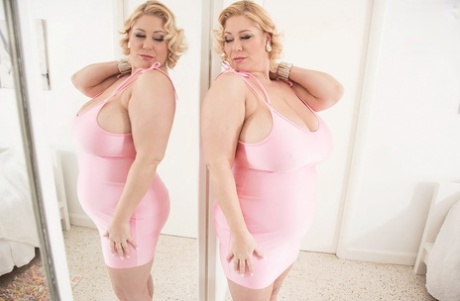 Blonde BBW Samantha Holds Her Large Breasts While Licking A Mirror