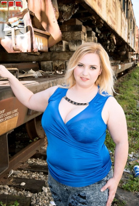 Inside a boxcar, Nikky Wilder of BBCW exposes her large buttocks.