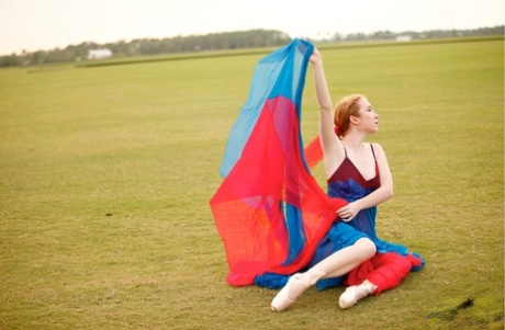In an extensive area, natural redhead Nicki Blue practices her ballerina moves.