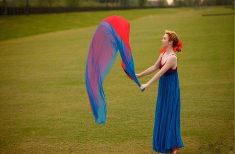 In an extensive area, natural redhead Nicki Blue practices her ballerina moves.