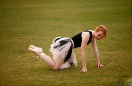 With an abundance of moves, Nicki Blue works on her ballerina skills with natural red hair and across a large field.