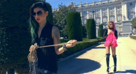 In public places, a submissive girl engages in sexual acts that are considered humiliating.
