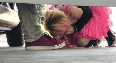 In public places, submissive girls engage in sexual activities that involve humiliating acts.