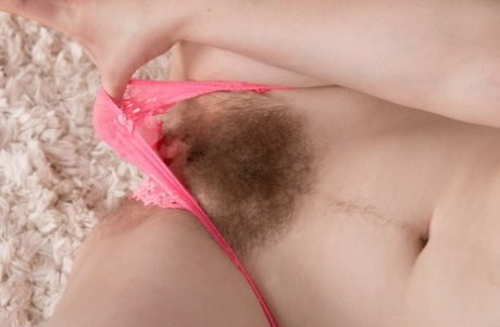 By exposing her thick beard, Kinky Alice Wonder is sure to greet you with happiness.