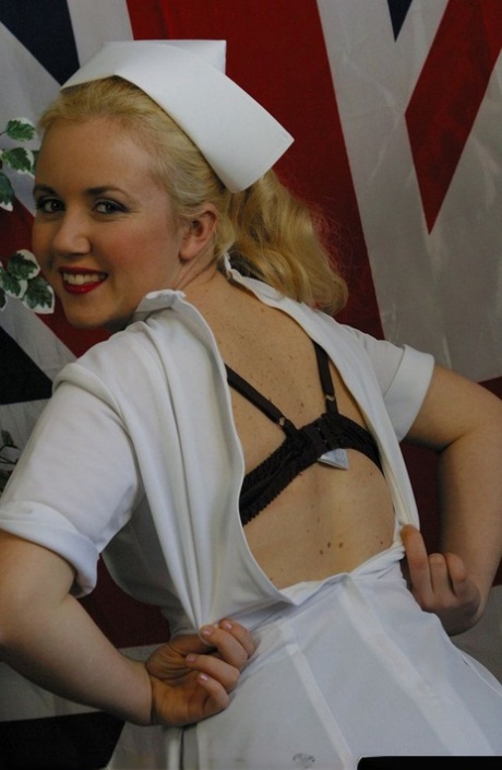 Before displaying tits and twat in nylons, the choosy blonde nurse removes her uniform.