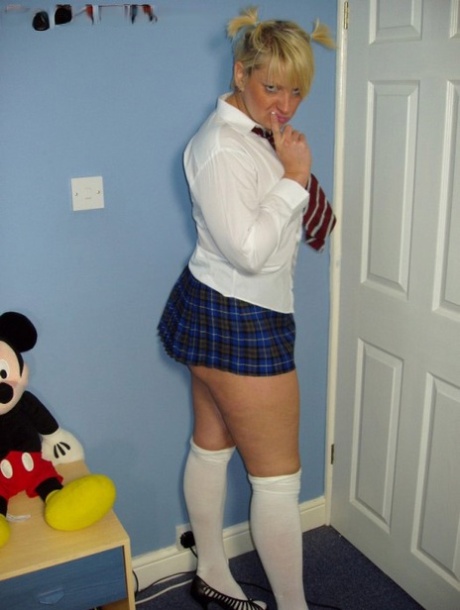 Older UK amateur Daniella English slides panties aside in schoolgirl attire