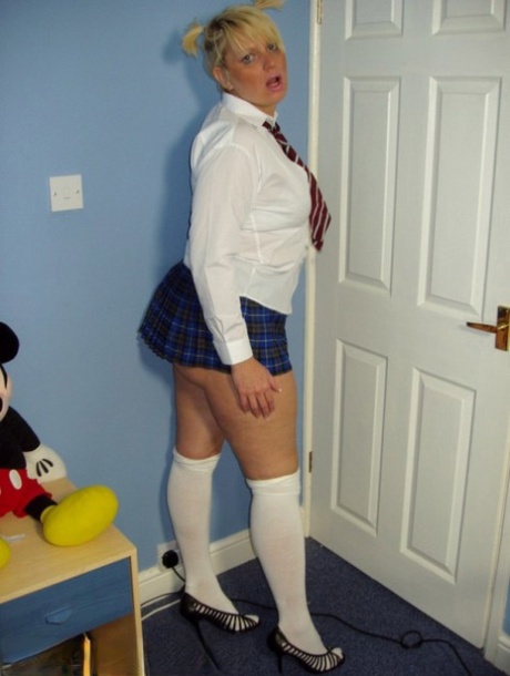 Older UK amateur Daniella English slides panties aside in schoolgirl attire