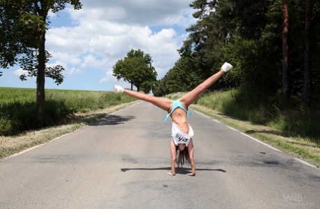 Hot teen Sabrisse does a handstand on the road before getting naked in a field - PornHugo.net
