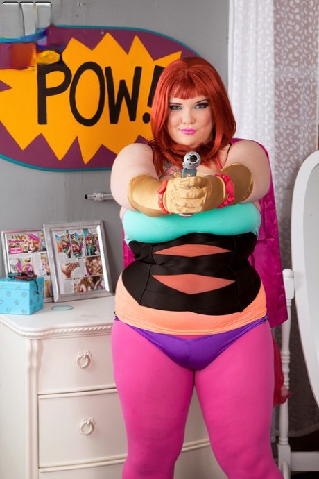 Redheaded fatty cat Kitty Mcpherson releases her large breasts from cosplay costumes.