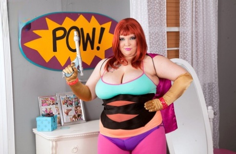 Cosplay attire allows Kitty Mcpherson, the redheaded cat with fatty breasts, to release her large boobs.