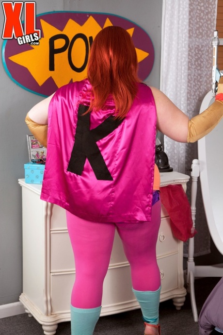 The cosplay attire of Kitty Mcpherson, the fatty redhead, releases her large breastbones.