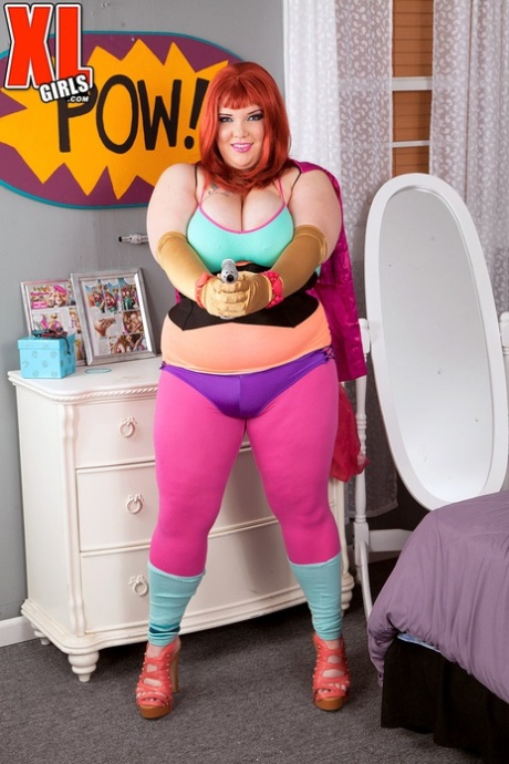 Redheaded fatty cat Kitty Mcpherson releases her large breasts from cosplay costumes.