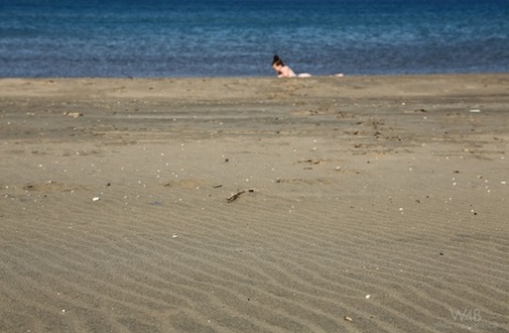 Beach Beauty Emily Sunbathing Naked On The Sand Spreading Long Legs Wide Open