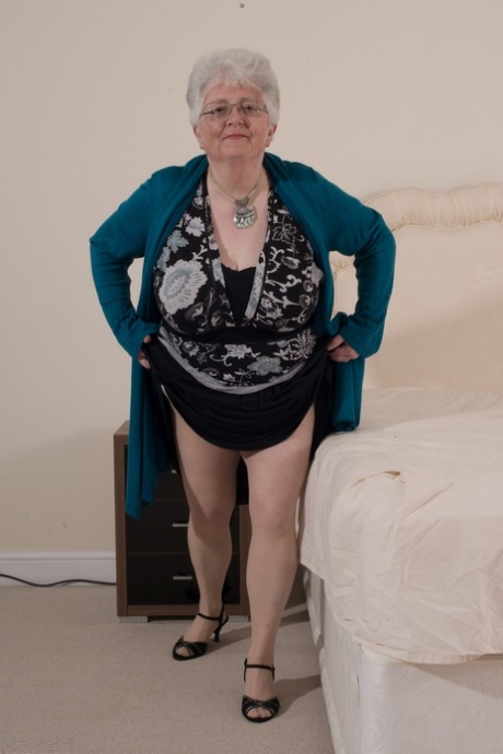 The overweight British grandmother shaves her nude breasts with her hands.