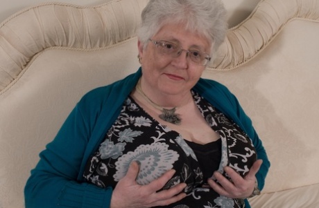 To hide her boobs, the overweight grandmother of Britain uses both hands to cover them with her own.