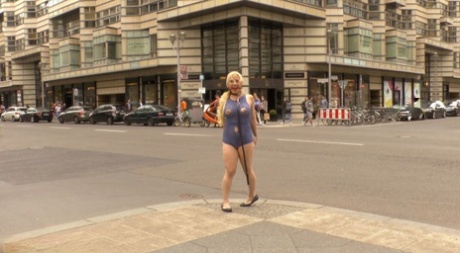 A naked blonde slave pees on a public street before engaging in sexual activity in a public place.