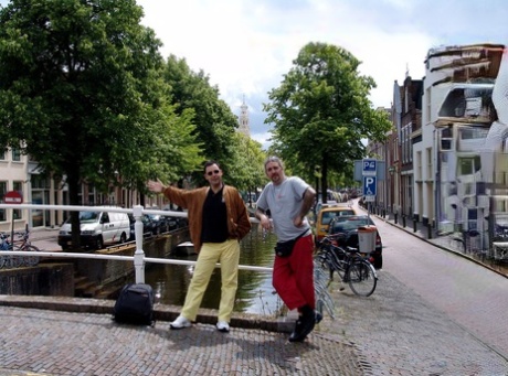 Tourists in the red light district fuck an overweight hooker.