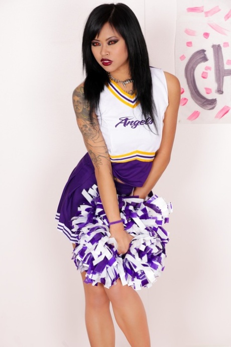 In her running shoes instead of her uniform, Krissie Dee as an Asian cheerleader moves forward.