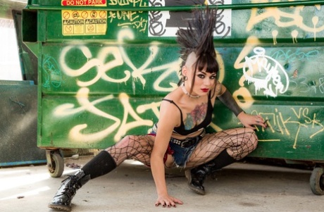 Tattooed punk rocker Amelia Dire stripped naked with hair in a Mohawk style.