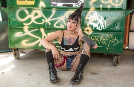 The tattooed punk rocker Amelia Dire stripped naked and sported her trademark mohawk hairstyle.