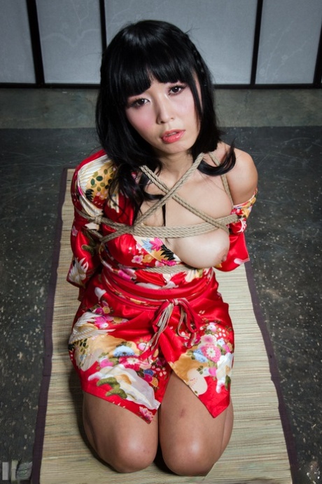 Beautiful Asian girl Marica Hase is suspended by ropes with red toenails