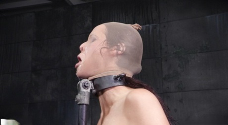 Syren de Mer, a female sex slave, has her mouth open and her head covered with a nylon.