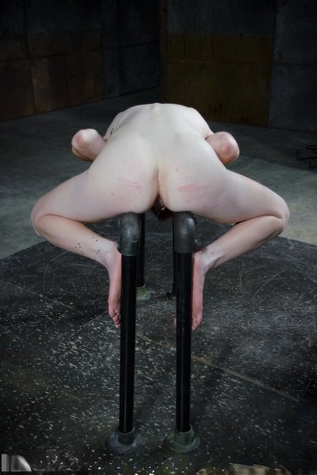 During her bondage, Ivy Addams displays cane marks on her naked redhead.