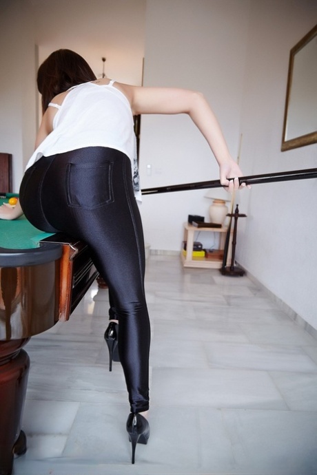 On a pool table, Helen G appears in skin tight pants and topless.