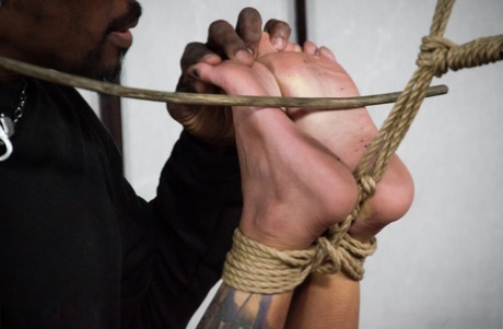 In the nude, black girl Jessica Creepshow finds herself suspended by rope.