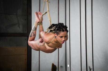 Black girl Jessica Creepshow reaches for the rope and falls naked in the nude.