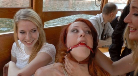 Exposed redheads are compelled to engage in public humiliating sexual acts.