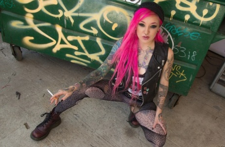 Smoking tattooed Kelsi Lynn in ripped pantyhose flaunting naked ass in alley #1