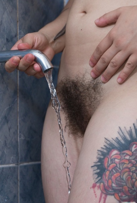 Before showering, Sue exposes her hairy pits and bush while being a busty dyke.