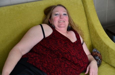 BBW from Britain wears black boots and mesh nylons to expose her saggy old breasts.