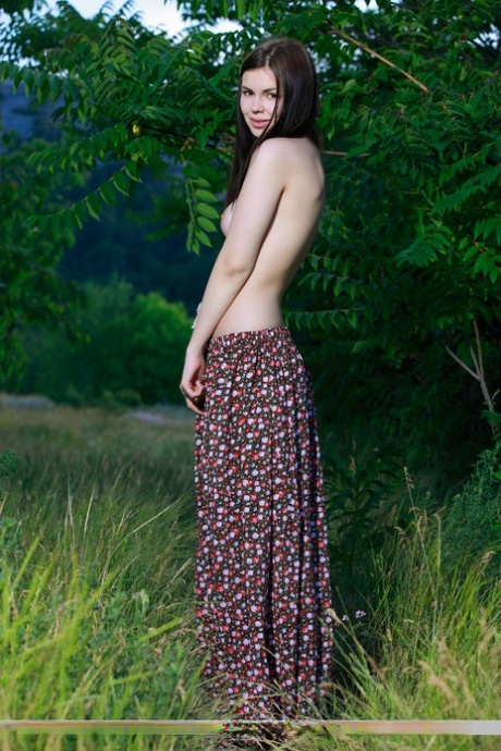 Glamour model Karolina Young, pictured naked in the forest as she poses.