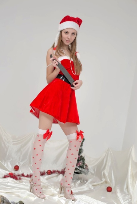 Slim teen Catalina removes Christmas clothes to pose nude in cute OTK socks