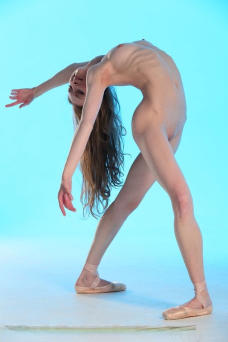 Annett A, the flexible dancer, removes her pantyhose and white skirt to reveal tiny tits.