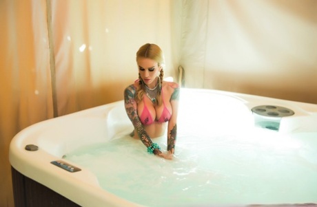 Heavily inked girl Sarah Jessie sucks a cock while wearing a bikini in a tub