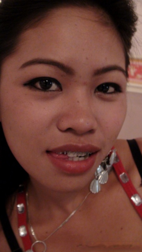 In front of a sex tourist, a small Filipina girl acts by undressing and masturbating on a bed.
